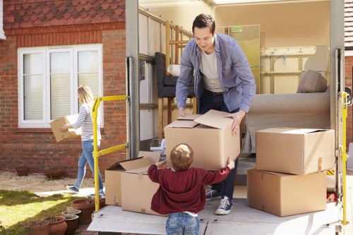 Careful lifting and transport of large furniture items