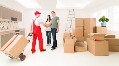 Professional movers handling household furniture in Battersea